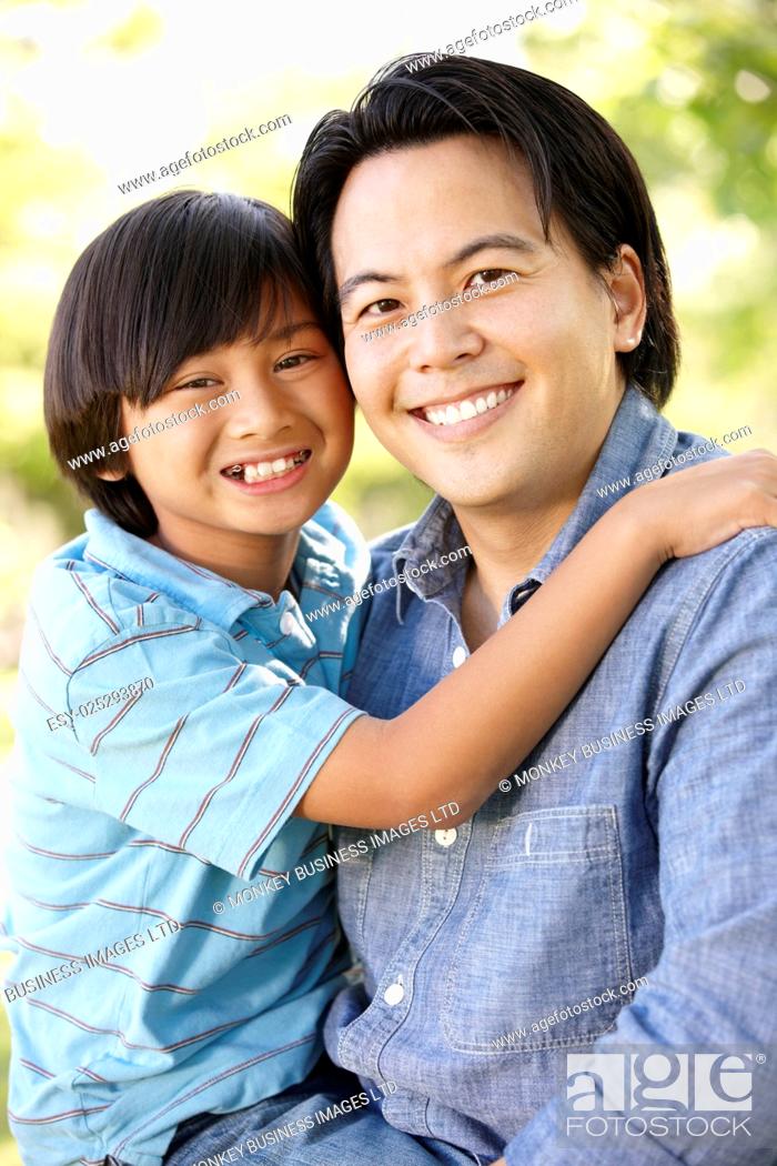 Stock Photo: Portrait Asian father and son outdoors.