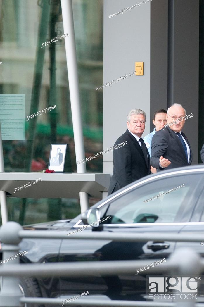 Stock Photo: German President Joachim Gauck (l) and French ambassador, Philippe Etienne, hug outside the French embassy in Berlin, Germany, 14 November 2015.