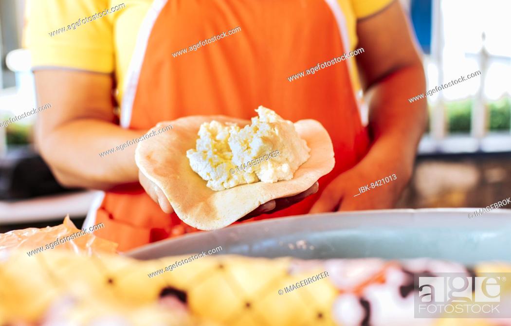 Stock Photo: Hands of a vendor showing traditional raw pupusa. Elaboration of traditional pupusas, elaboration of the dough for traditional Nicaraguan pupusas.