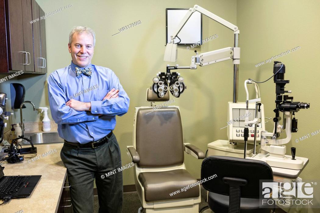 Stock Photo: Caucasian man ophthalmologist in his examination room.