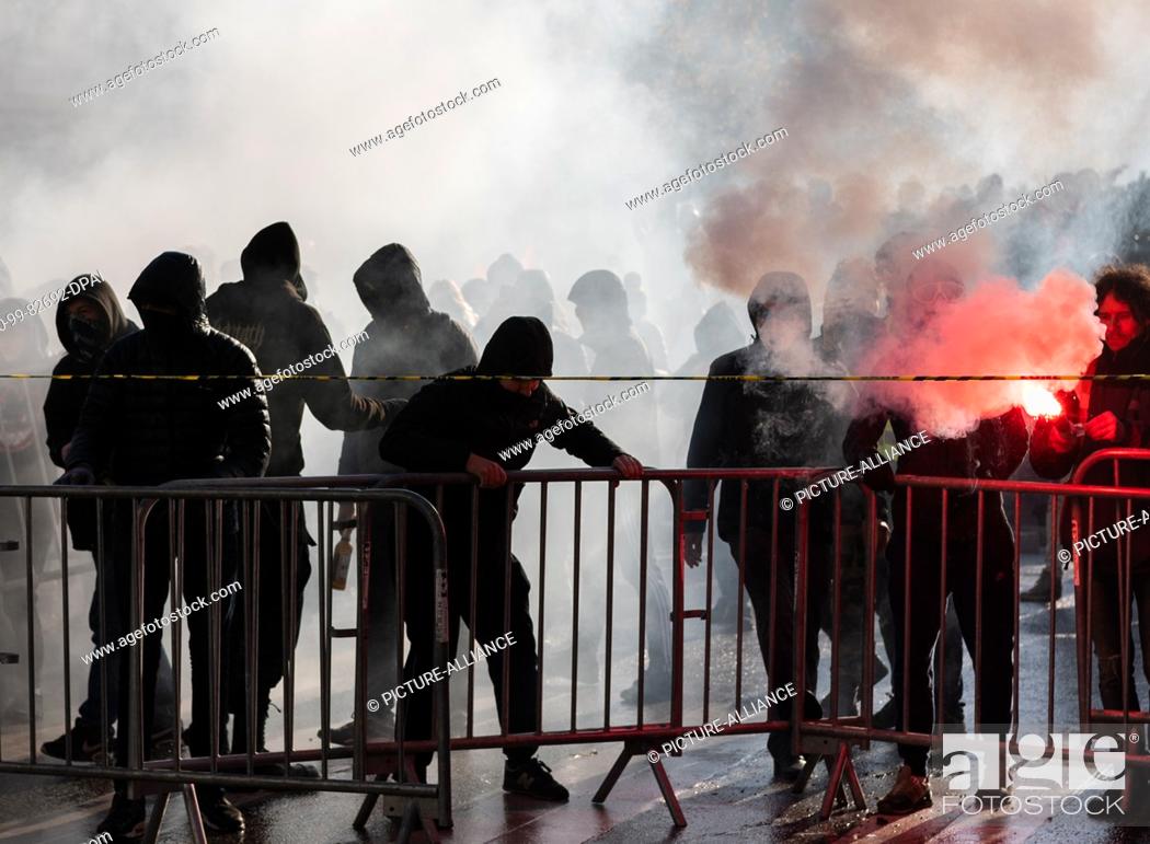 Stock Photo: 10 December 2019, France (France), Lyon: Demonstrators build a barricade during a demonstration in the context of strikes and protests against the pension.