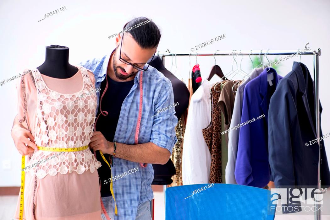 Stock Photo: Male tailor working in the workshop on new designs.