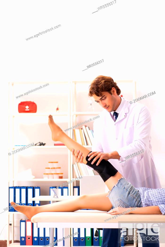 Stock Photo: Young female patient visiting male doctor traumatologist.