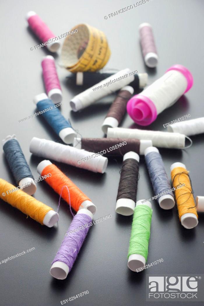 Stock Photo: Spool of thread and pins. Sewing accessories.
