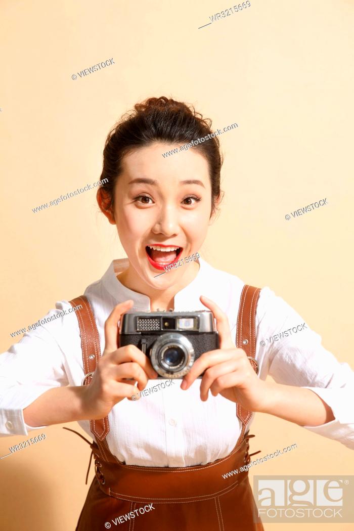 Photo de stock: Young woman with the camera.
