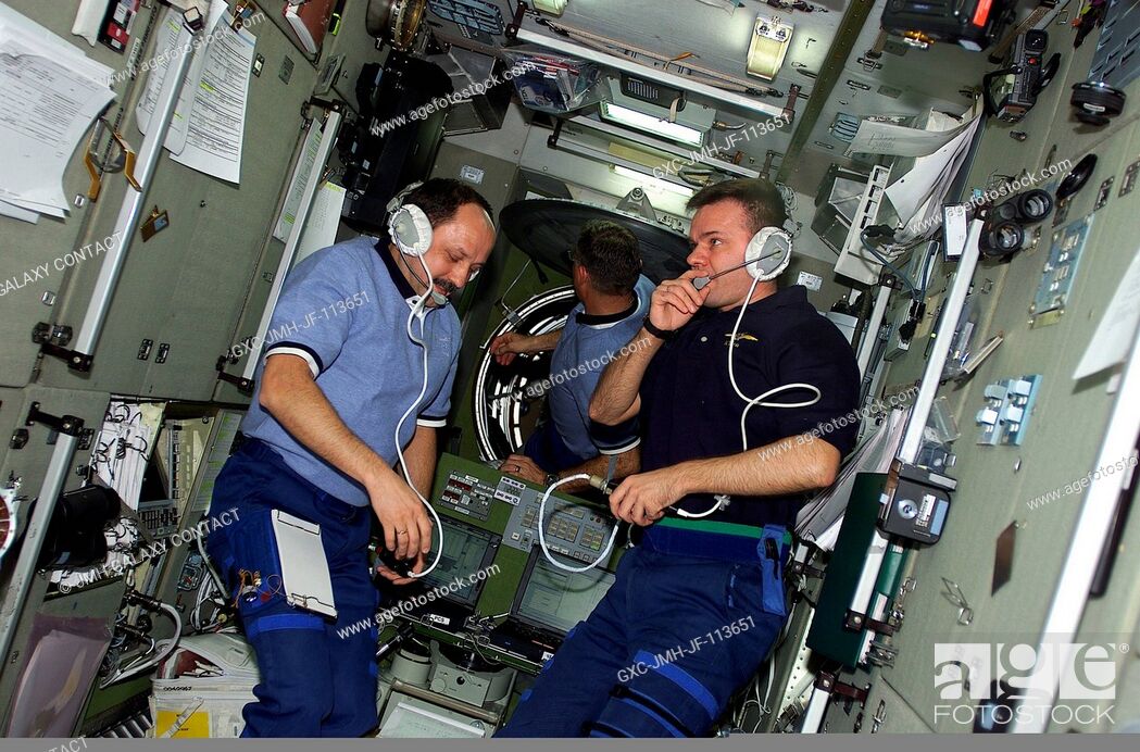 Stock Photo: Left to right, cosmonaut Yury V. Usachev, astronaut James S. Voss and cosmonaut Yuri P. Gidzenko visit on the International Space Station soon after hatches.