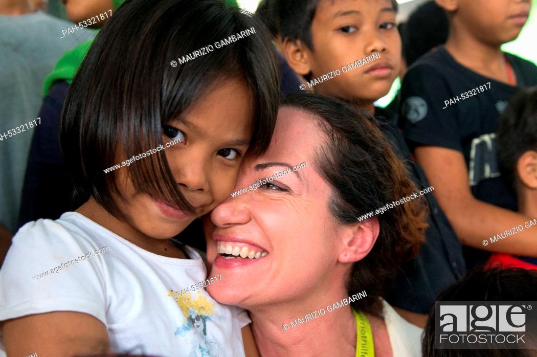Stock Photo: Actress Natalia Woerner (C) poses with former street children in Jakarta,  Indonesia, 03 November 2014. She supports Kindernothilfe.