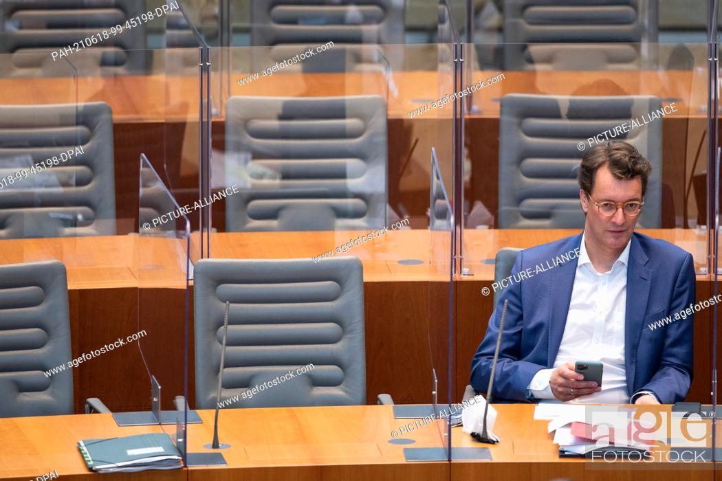 Stock Photo: 18 June 2021, North Rhine-Westphalia, Duesseldorf: Hendrik Wüst (CDU), Minister of Transport, sits in the plenary session of the state parliament.