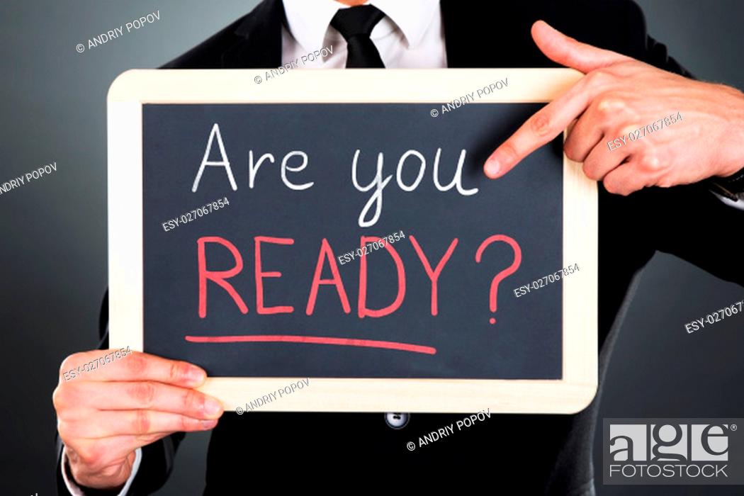 Stock Photo: Midsection of young businessman pointing Webinar sign drawn on slate over gray background.