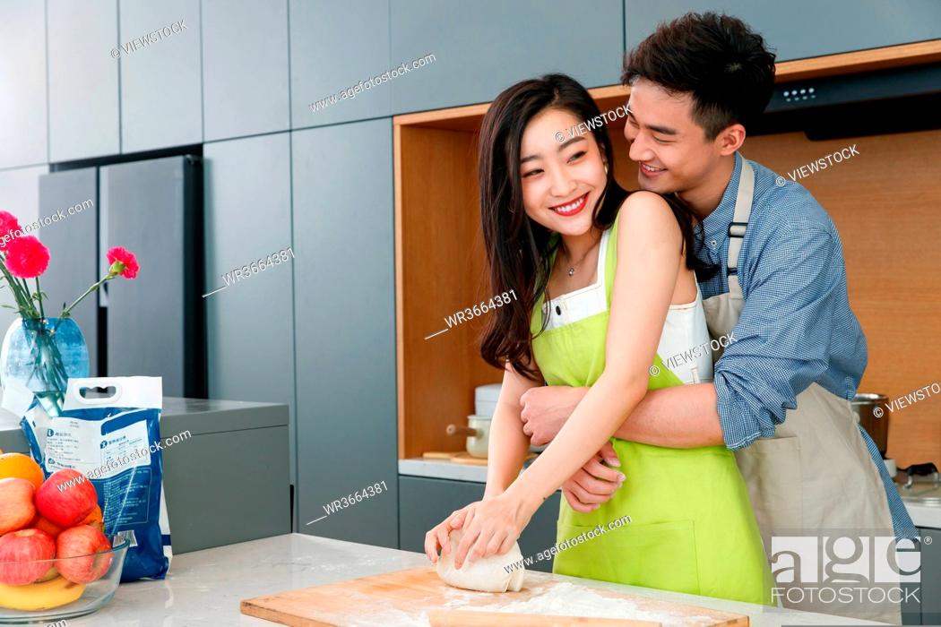Stock Photo: Happy couples of cooking in the kitchen.