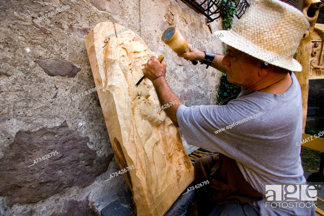 Stock Photo: 'Dal Medioevo al Terzo Millennio' Exhibition. The wood-carver Gianmario Monella at work. Sellero. Lombardia-Valcamonica. Italy.