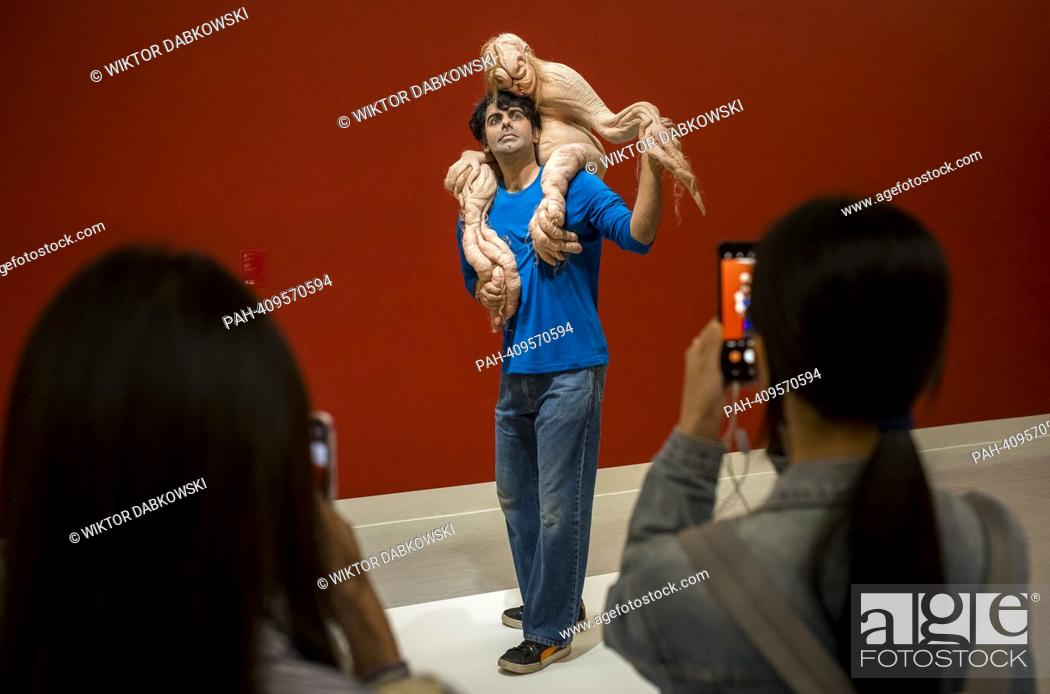 Stock Photo: People look at The Sapling a sculpture by Patricia Piccinini during the SUPERNATURAL: Sculptural Visions of the Body exhibition in Taipei.