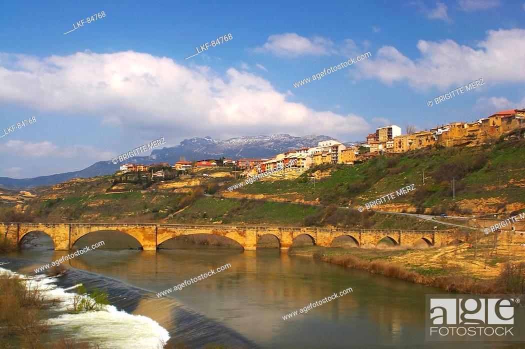 Stock Photo: Medieval stone bridge over river, Rio Ebro, in Spring, San Vicente de la Sonsierra, La Rioja, Spain.