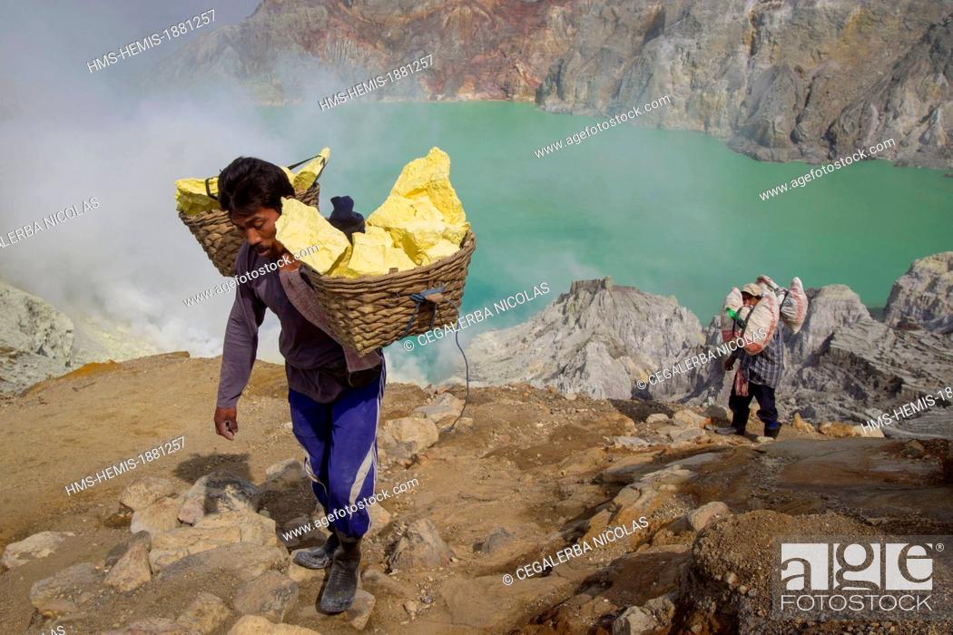 Stock Photo: Indonesia, Java Island, East Java province, Mining Sulfur by hand in Kawah Ijen volcano (2500m), miner carrying sulfur.