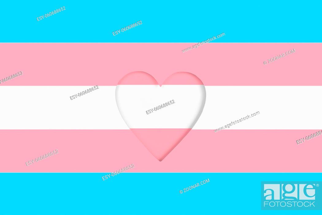 Stock Photo: Transgender flag background. Printed cardboard with die-cut heart shape. Top view.