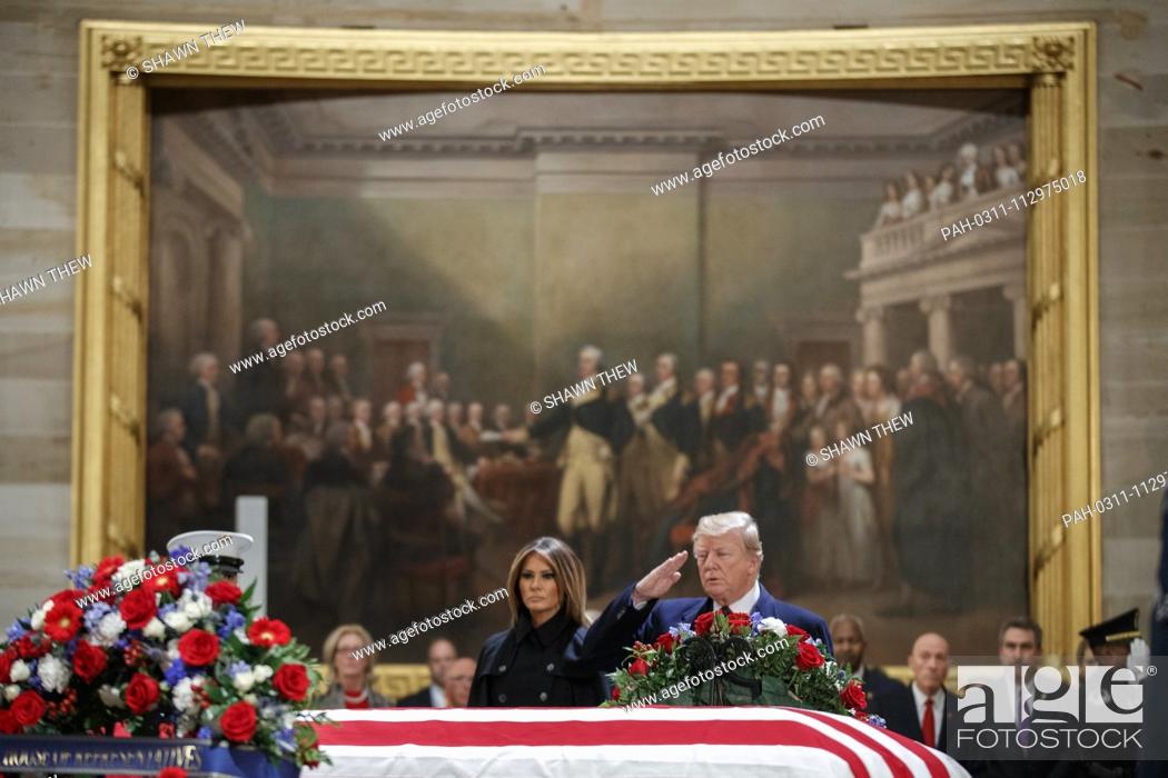 Stock Photo: US President Donald J. Trump, with First Lady Melania Trump, salutes the casket containing the body of former US President George H.W.