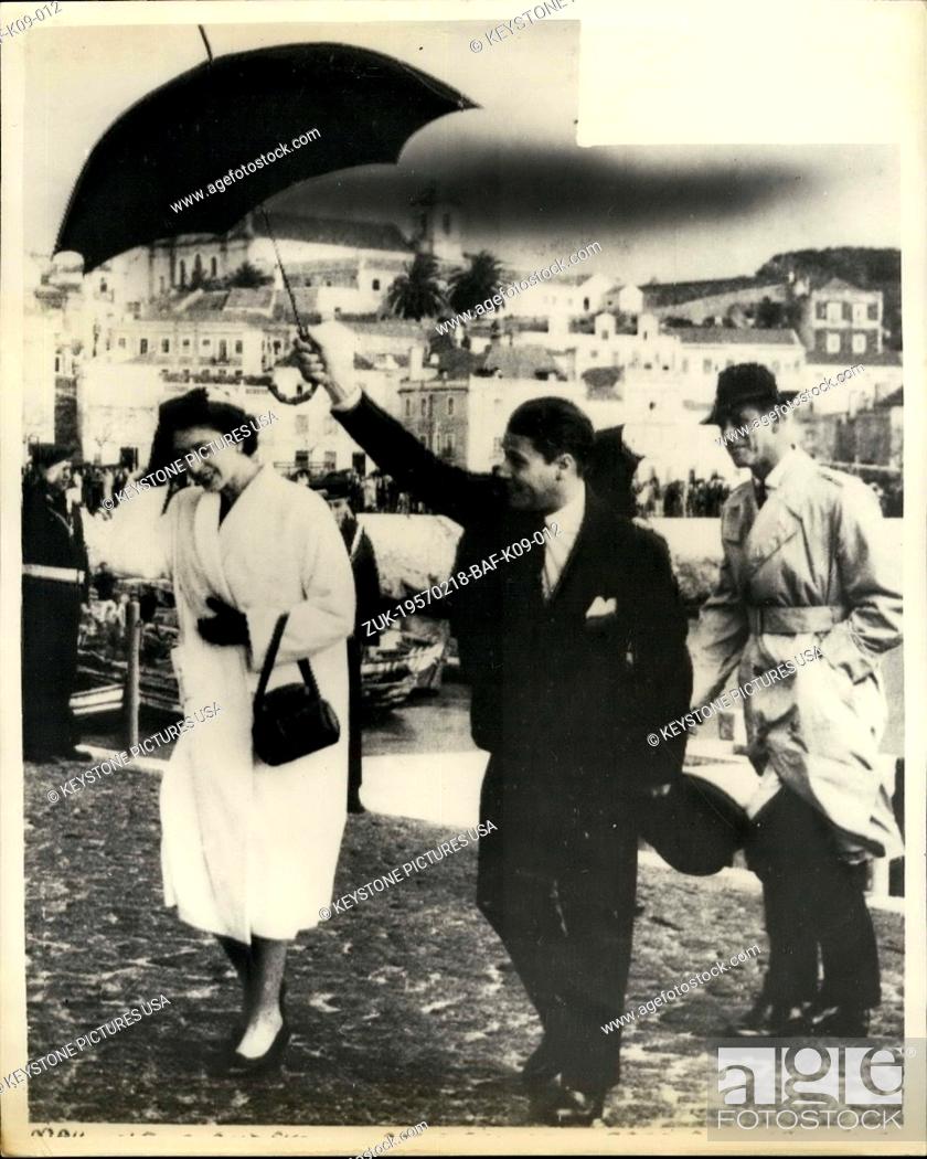 Stock Photo: Feb. 18, 1957 - Queen And Duke In Portugal. Photo shows H.M. The Queen, protected by an umbrella, crosses the cobbled quay at Setubal, Portugal.
