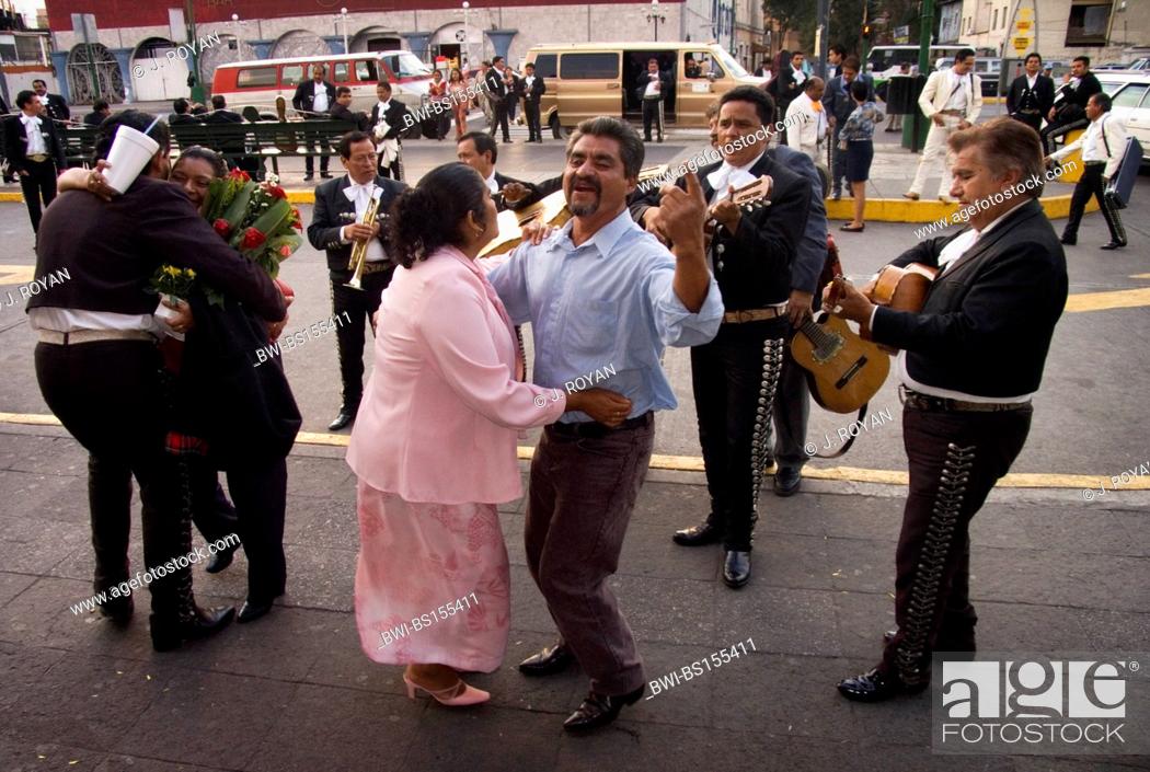 Stock Photo: A middle age couple dances and sings during a 'serenata'. Mariachis in Plaza Garibaldi, Mejico, Mexico, Mexico City.