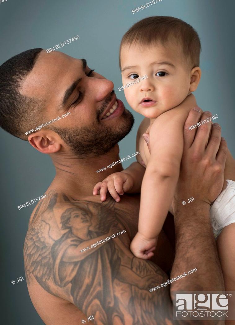 Father with tattoos holding baby son, Stock Photo, Picture And Royalty Free  Image. Pic. BIM-BLD157485 | agefotostock