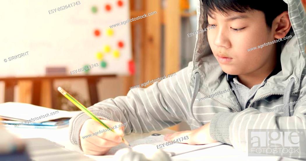 Cute Asian Teen Boy Doing Your Homework At Home Stock Photo Picture And Low Budget Royalty Free Image Pic Esy Agefotostock