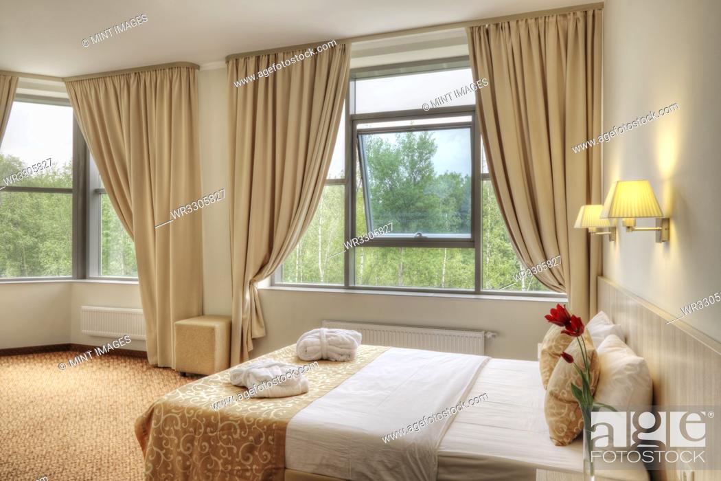 Stock Photo: Bed and curtains in hotel room.