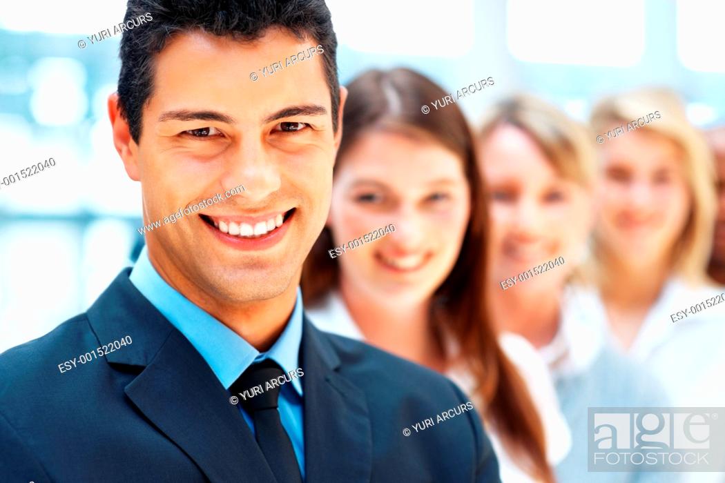 Stock Photo: Focus on businessman with colleagues standing behind him.