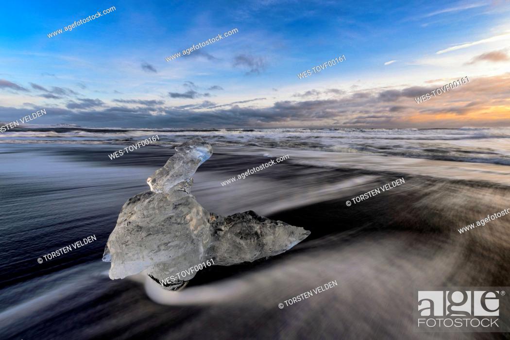 Stock Photo: Iceland, Ice chunk lying at shore of¶ÿJokulsarlon¶ÿat dusk.