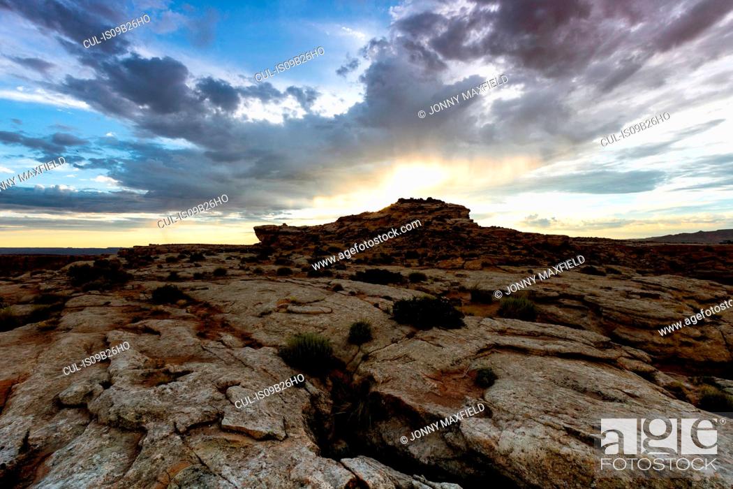 Stock Photo: View of sunburst over rock formation, Alstrom Point, Utah, USA.