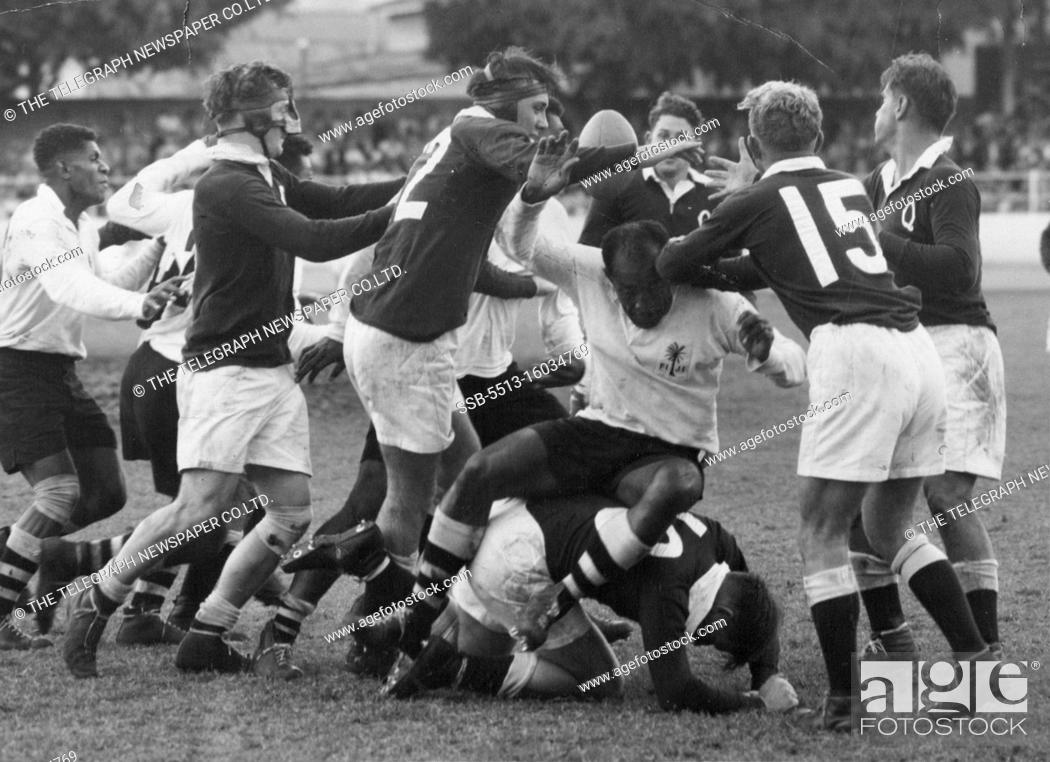 Stock Photo: Fijian Captain Tuitava sip on Queensland forward O'Brien in a saaammage for the ball. May 29, 1954. (Photo by The Telegraph Newspaper Co.Ltd.).