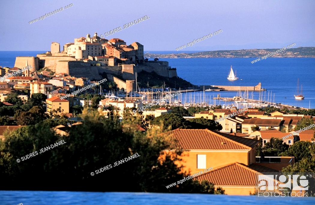 Stock Photo: France, Haute Corse, Balagne region, Calvi, the citadel seen from the La Villa Hotel swimming-pool.