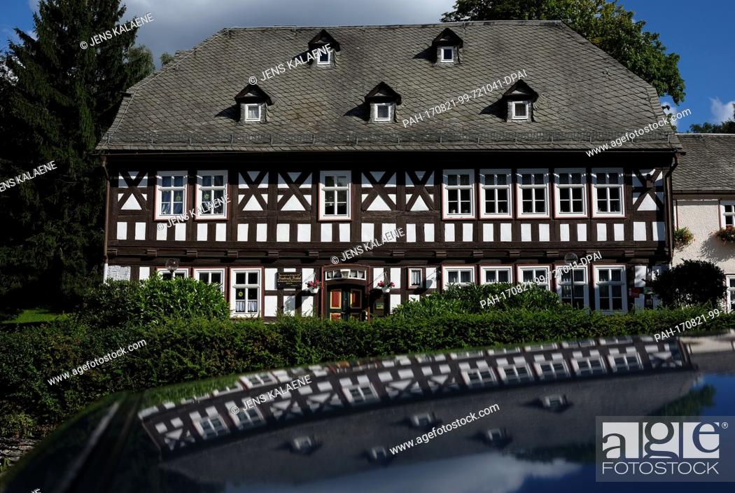 Stock Photo: Friedrich Froebel's birth house reflected in the roof of a car in Oberweissbach, Germany, 19 August 2017. The house is now a museum.