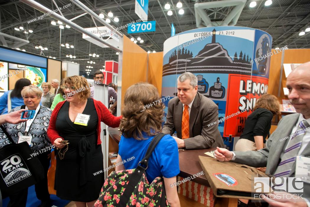 Stock Photo: Daniel Handler, known under the pen name of Lemony Snicket, signs at the Little, Brown booth at the huge Book Expo America at the Jacob Javits Convention Center.