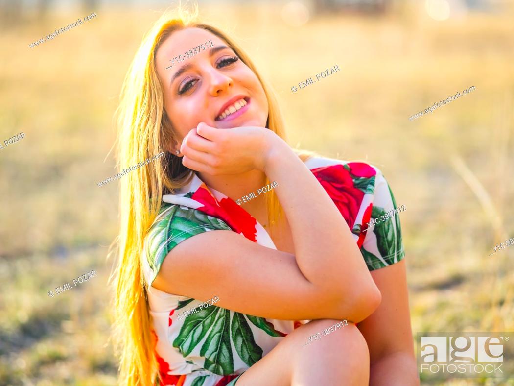 Stock Photo: Adolescent blonde girl happy close-up portrait giggling at camera.