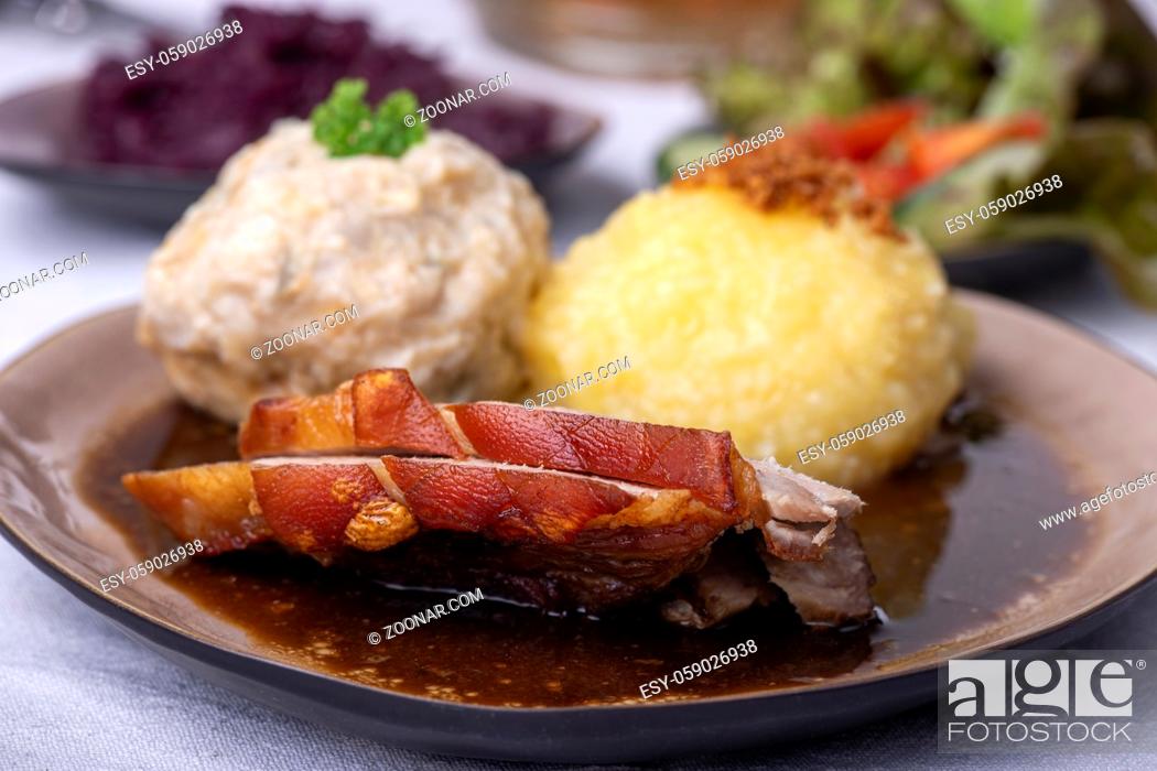 Stock Photo: bavarian roasted pork with different dumplings.