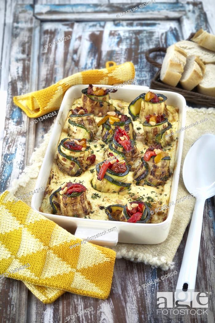 Stock Photo: Oven cooked courgette rolls with peppers and pine nuts.