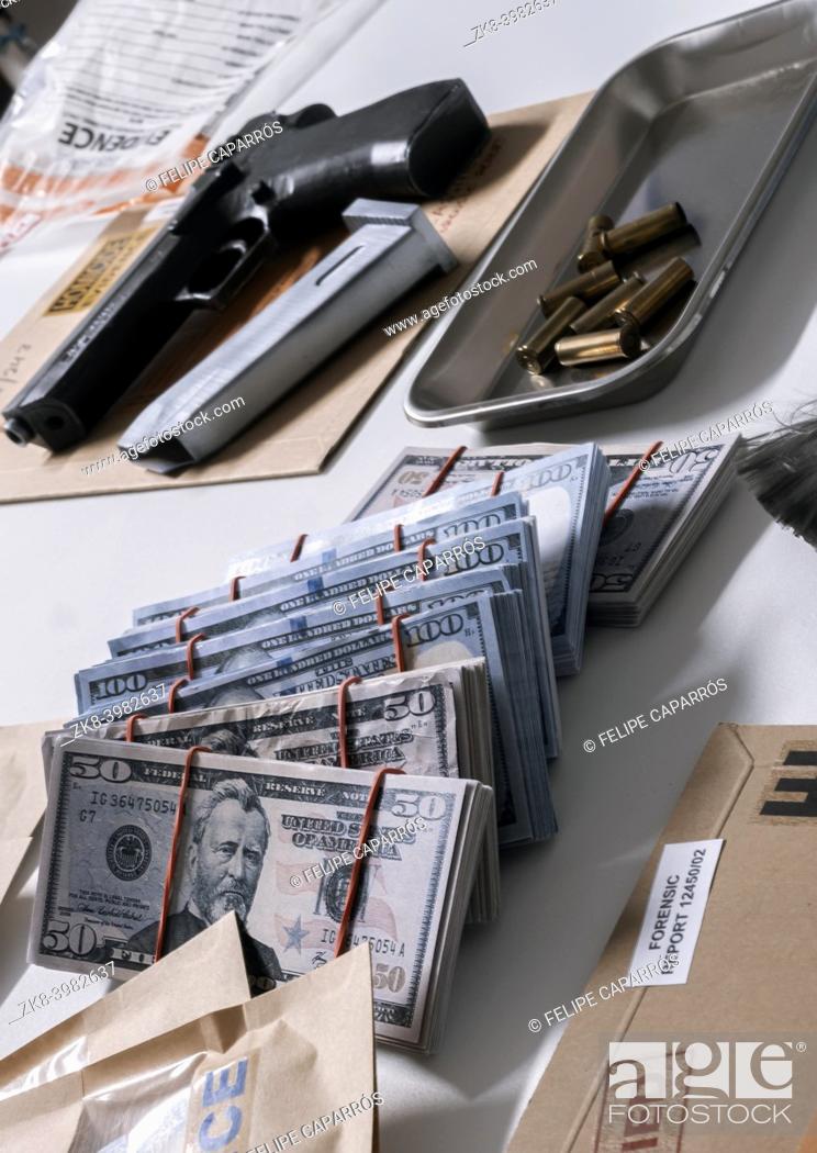 Stock Photo: Money and weapons in crime lab for investigation, conceptual image.
