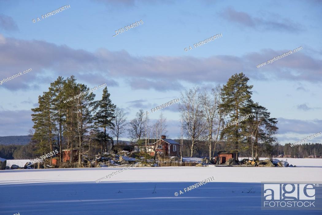 Stock Photo: Norrbranningen, Sweden A frozen lake and island on a sunny days.