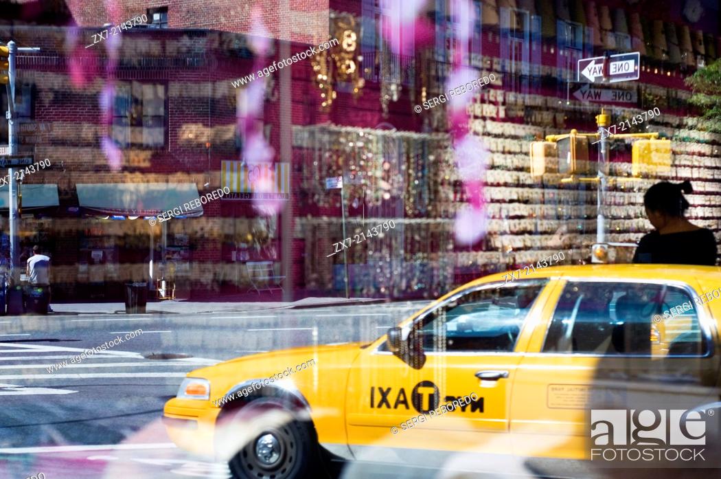 Stock Photo: Reflection of a taxi in a jewelery shop in Greenwich Village. Greenwich Village, or simply the Village, is a neighborhood in lower Manhattan that is bounded by.