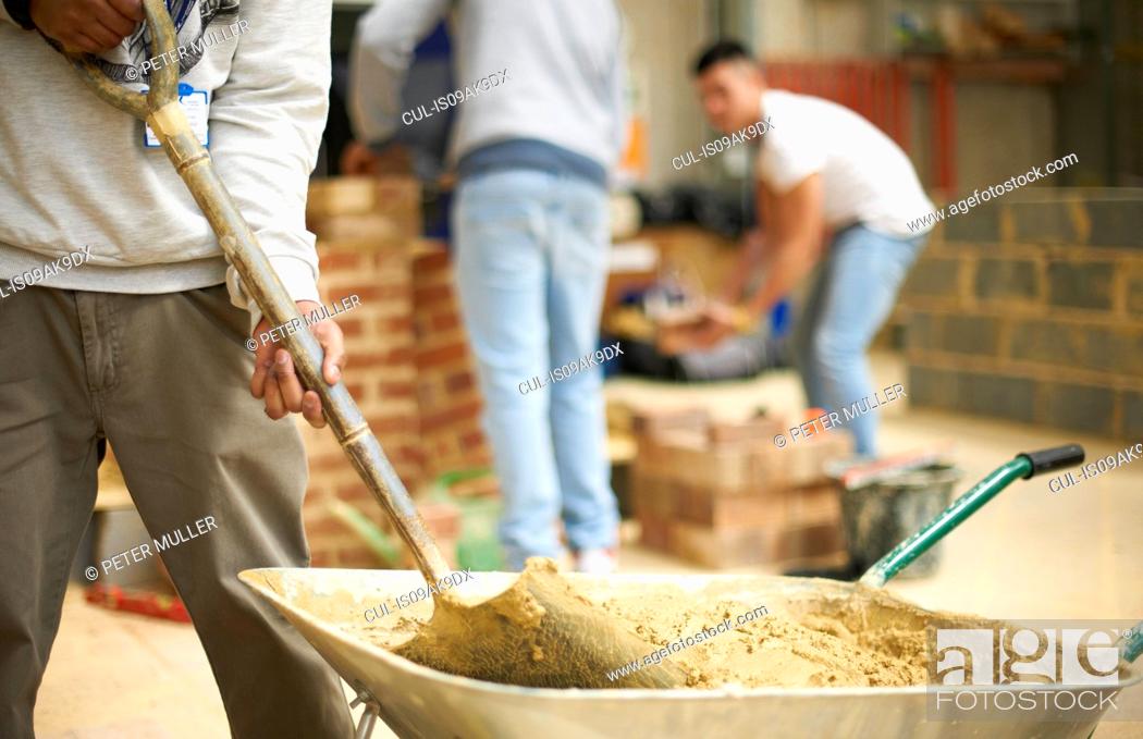 Stock Photo: Cropped shot of three male college students in bricklaying workshop.