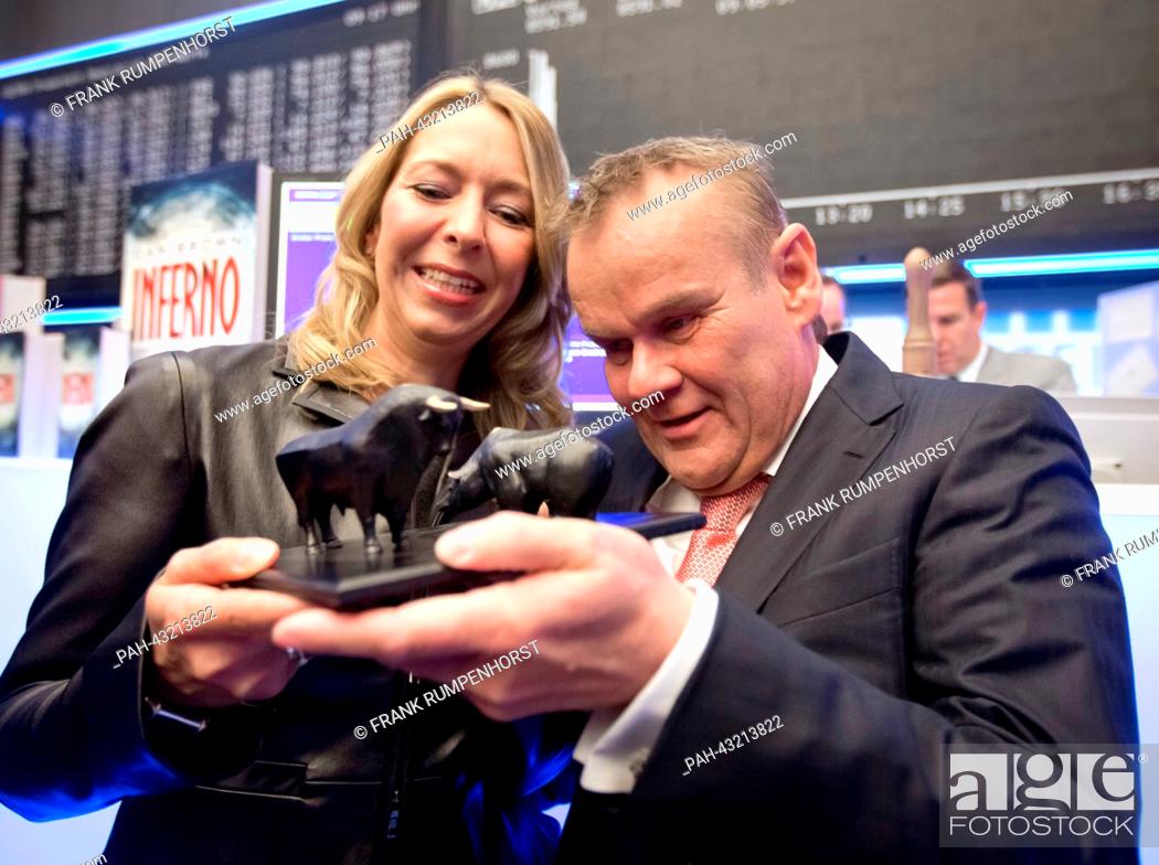 Stock Photo: Publishers Birgit and Stefan Luebbe view the tiny sculptures of bull and bear they received as a present from the Deutsche Boerse Group shortly after the.