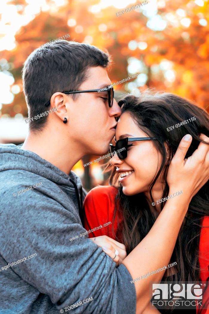 Stock Photo: Attractive couple lovers kiss in a park, during a romantic dating outdoors.