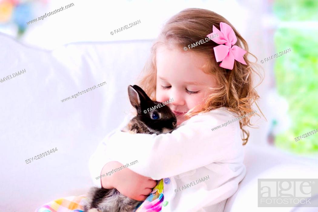 Child playing with a real rabbit. Kids play with pets. Little girl holding  bunny, Stock Photo, Picture And Low Budget Royalty Free Image. Pic.  ESY-028993484 | agefotostock