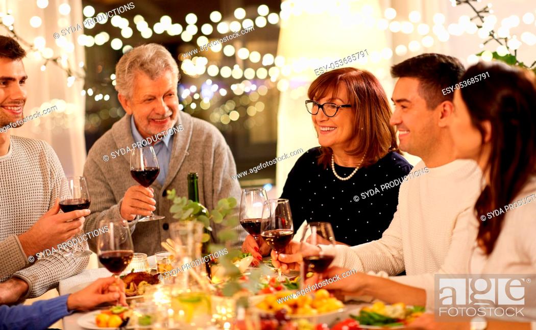 Stock Photo: happy family having dinner party at home.