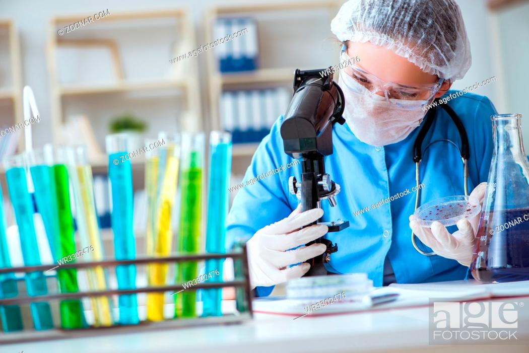 Stock Photo: Female scientist researcher doing experiments in laboratory.