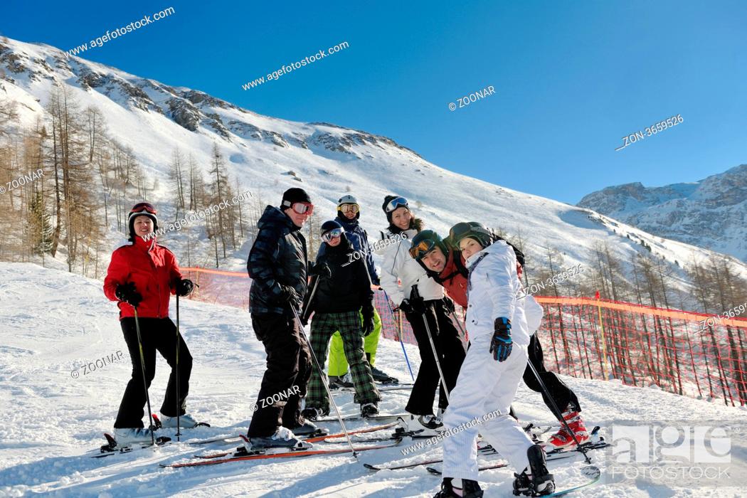 Stock Photo: happy people group have fun on ski snow at winter season on mountain with blue sky and fresh air.