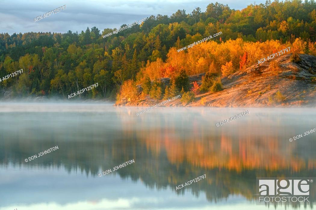 Stock Photo: Autumn reflections in Simon Lake at dawn, Greater Sudbury, Ontario, Canada.