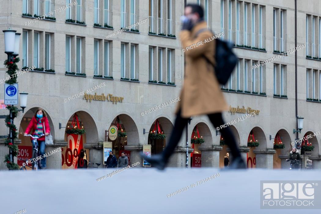 Stock Photo: 21 December 2020, North Rhine-Westphalia, Münster: A man walks across the Prinzipalmarkt. Photo: Rolf Vennenbernd/dpa. - Münster/North Rhine-Westphalia/Germany.
