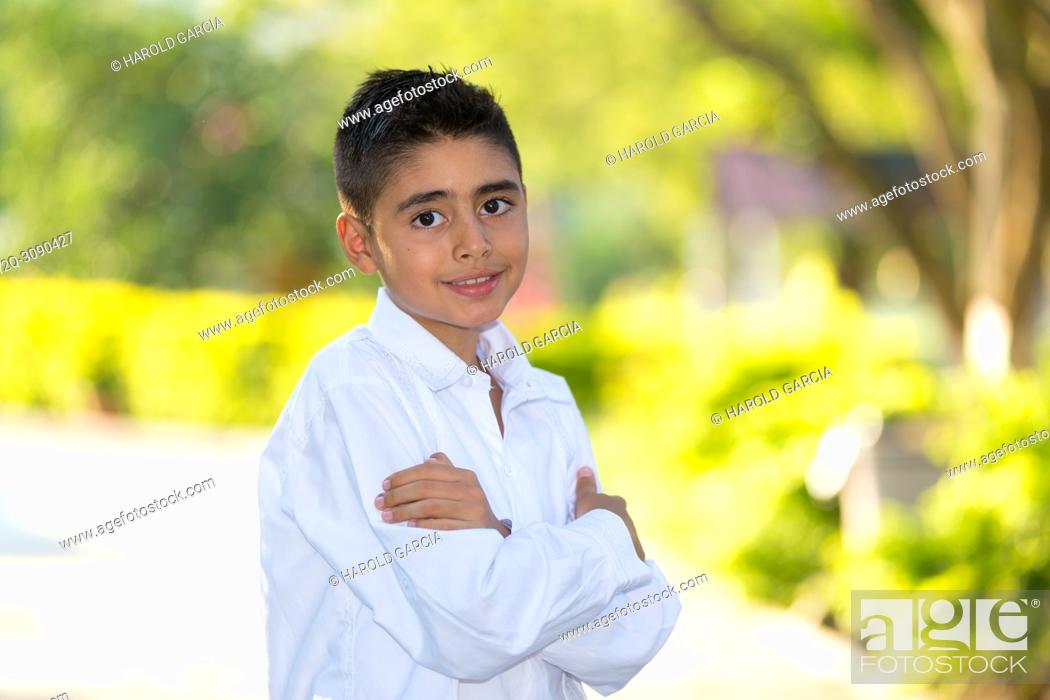 Stock Photo: Elegant young man in white clothes posing for the camera in a photo shoot.