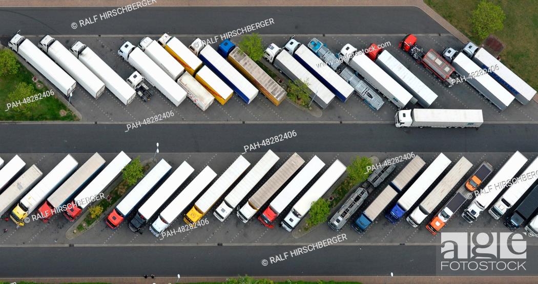 Stock Photo: The full truck parking lot at the rest stop is picture from the air in Michendorf,  Germany, 01 May 2014. Photo: RALF HIRSCHBERGER/dpa | usage worldwide.