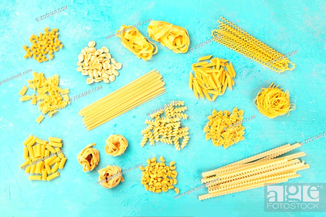 Stock Photo: Italian pasta variety, flat lay banner, shot from above on a teal blue background.